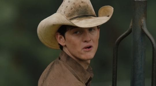 Yellowstone Spin-Off: Beth Dutton & Rip Wheeler's New Beginning 4 “Beth Dutton and Rip Wheeler in Yellowstone spin-off, standing together in front of a burning house, symbolizing their escape from the Dutton legacy and a dangerous new beginning.”